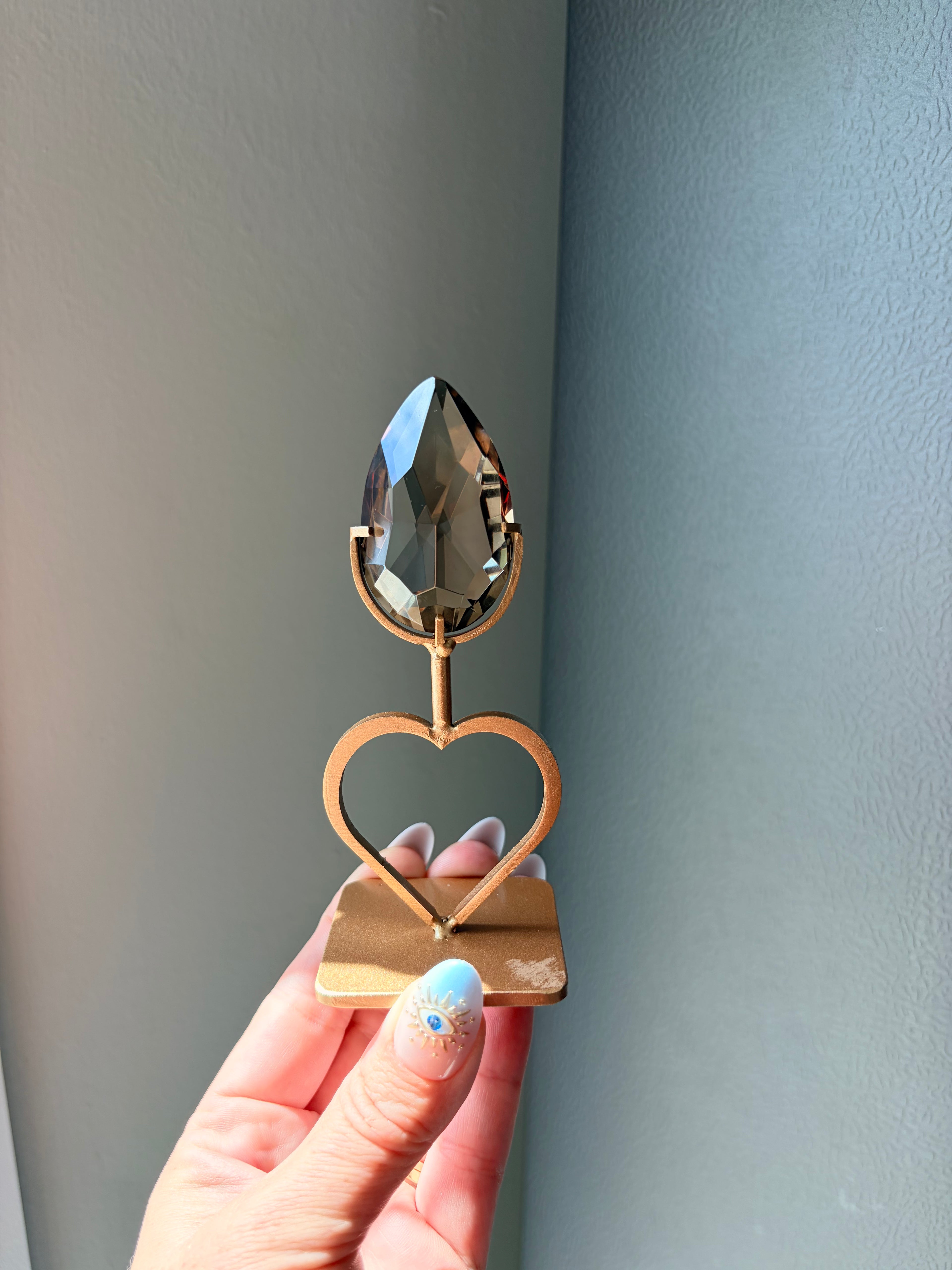Faceted Smoky Quartz Gem on Heart Gold Stand