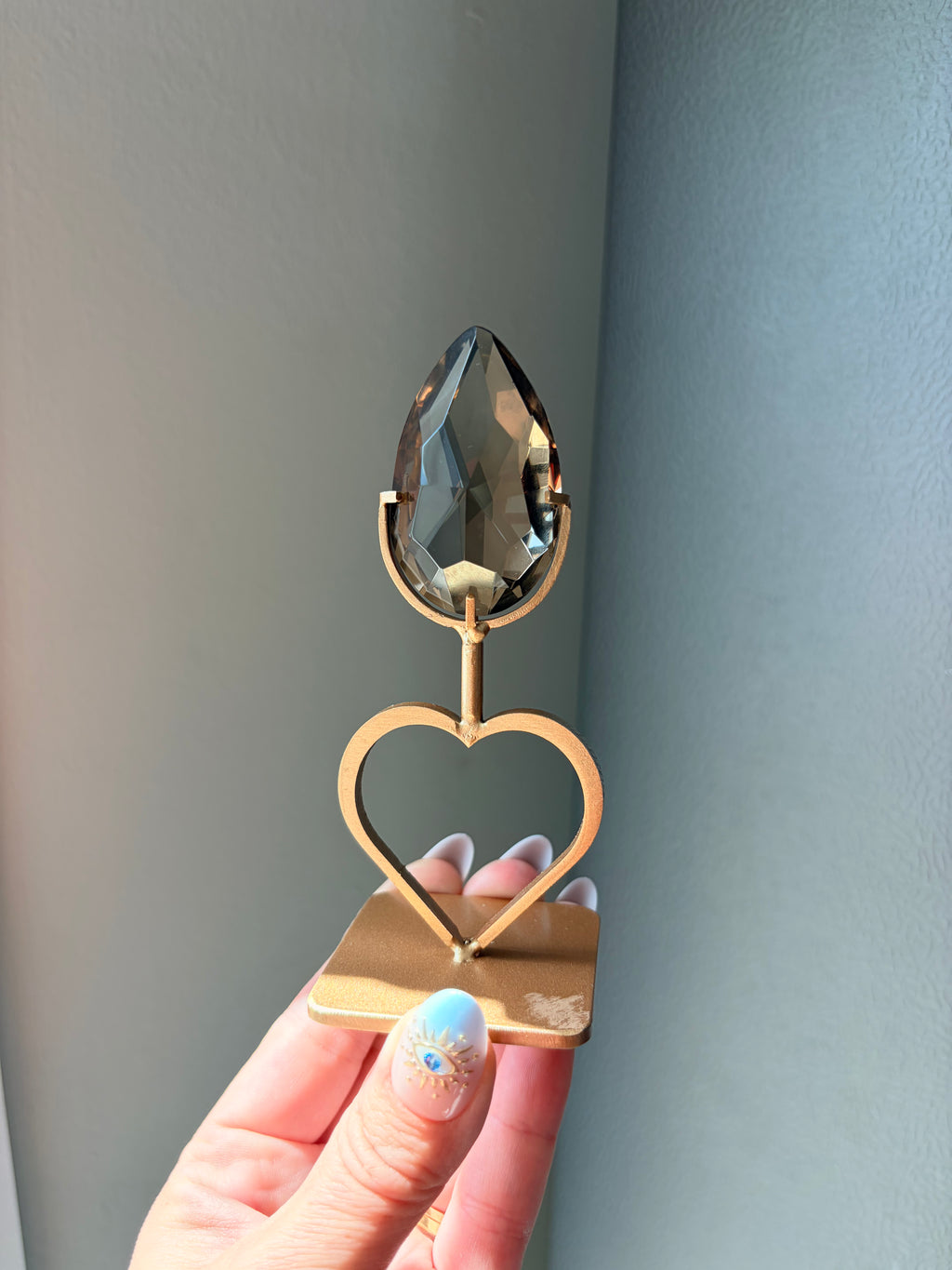 Faceted Smoky Quartz Gem on Heart Gold Stand