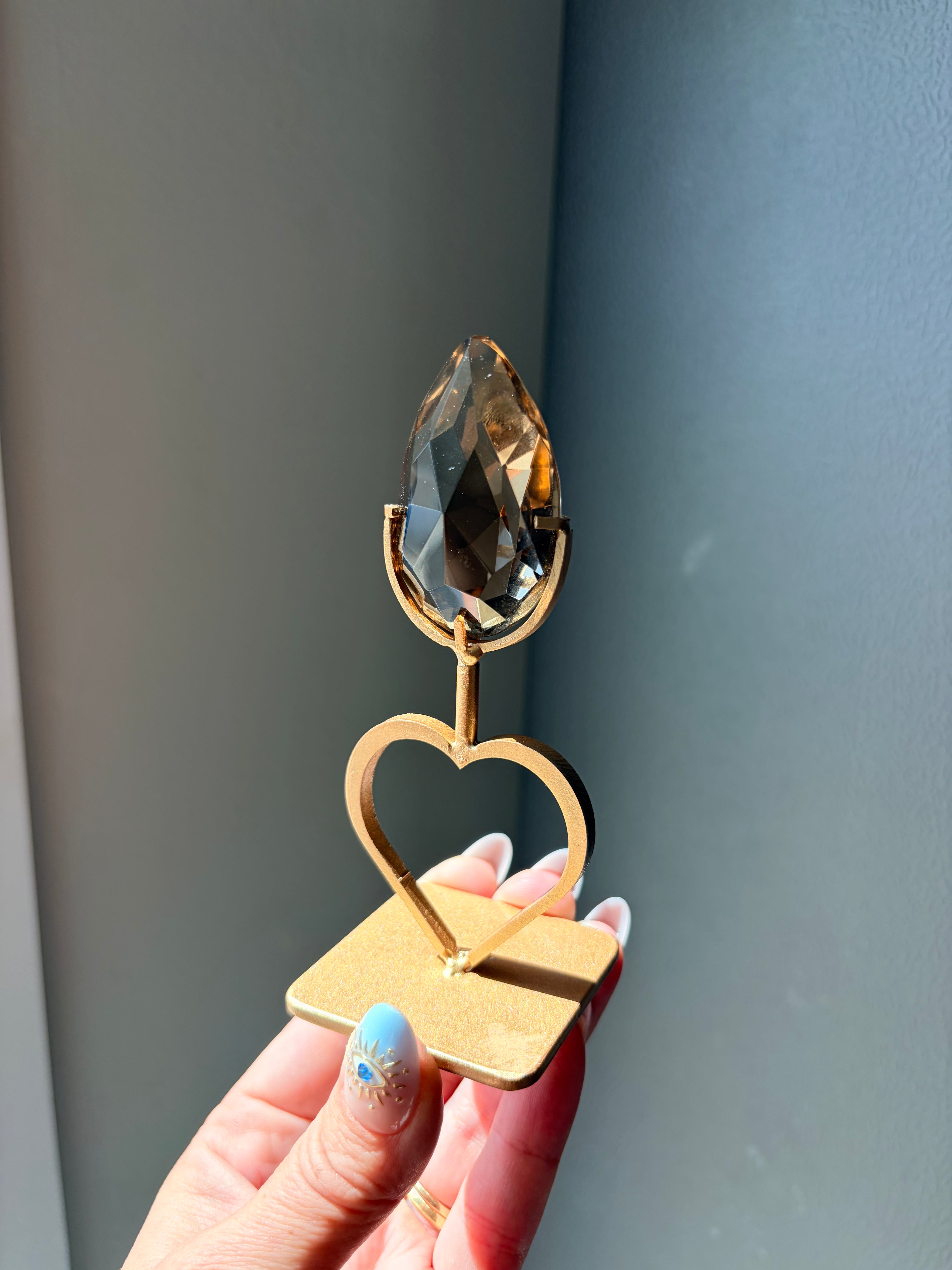 Faceted Smoky Quartz Gem on Heart Gold Stand