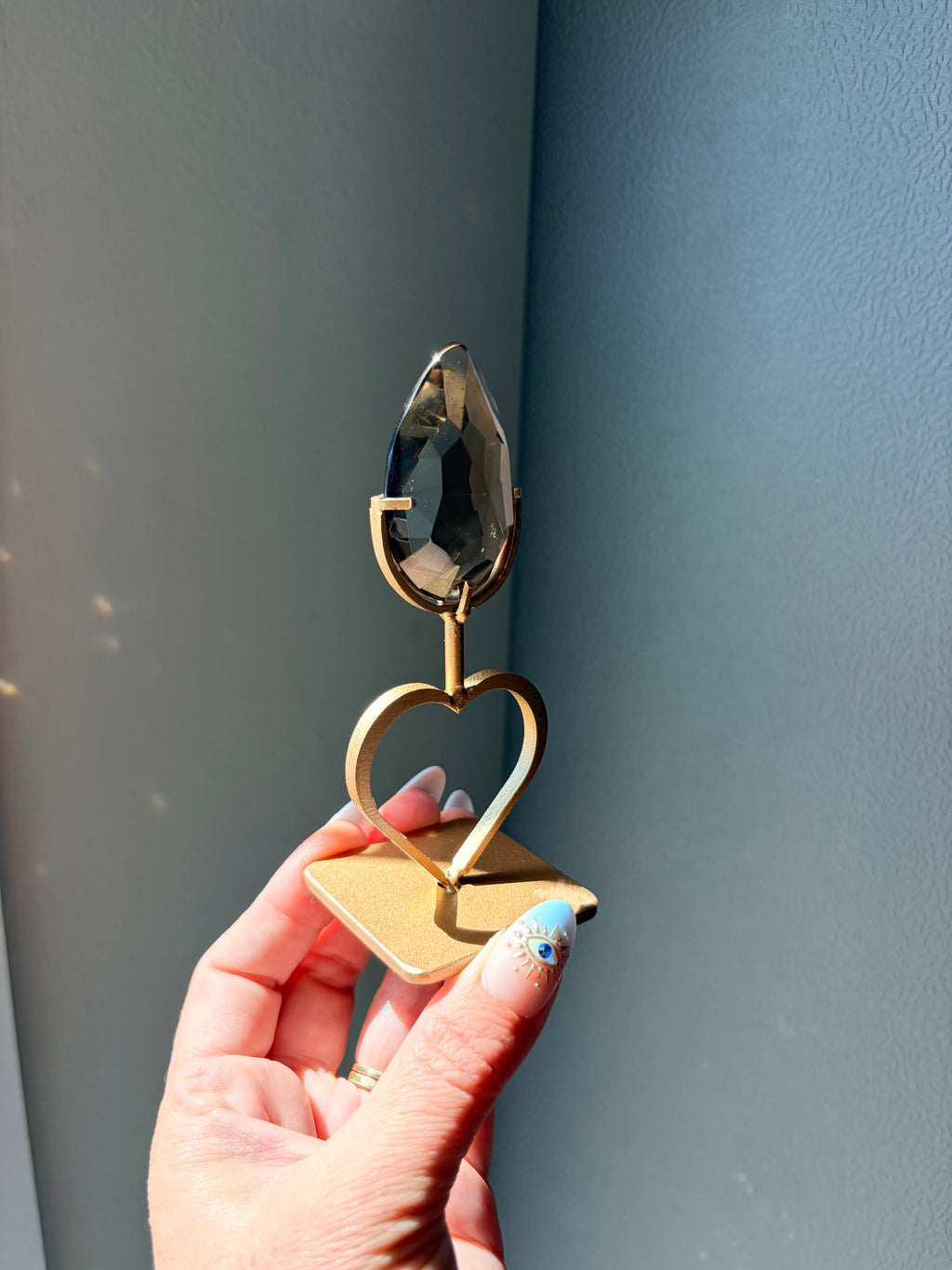 Faceted Smoky Quartz Gem on Heart Gold Stand