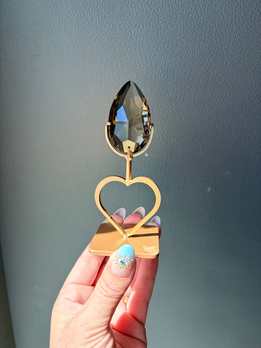 Faceted Smoky Quartz Gem on Heart Gold Stand
