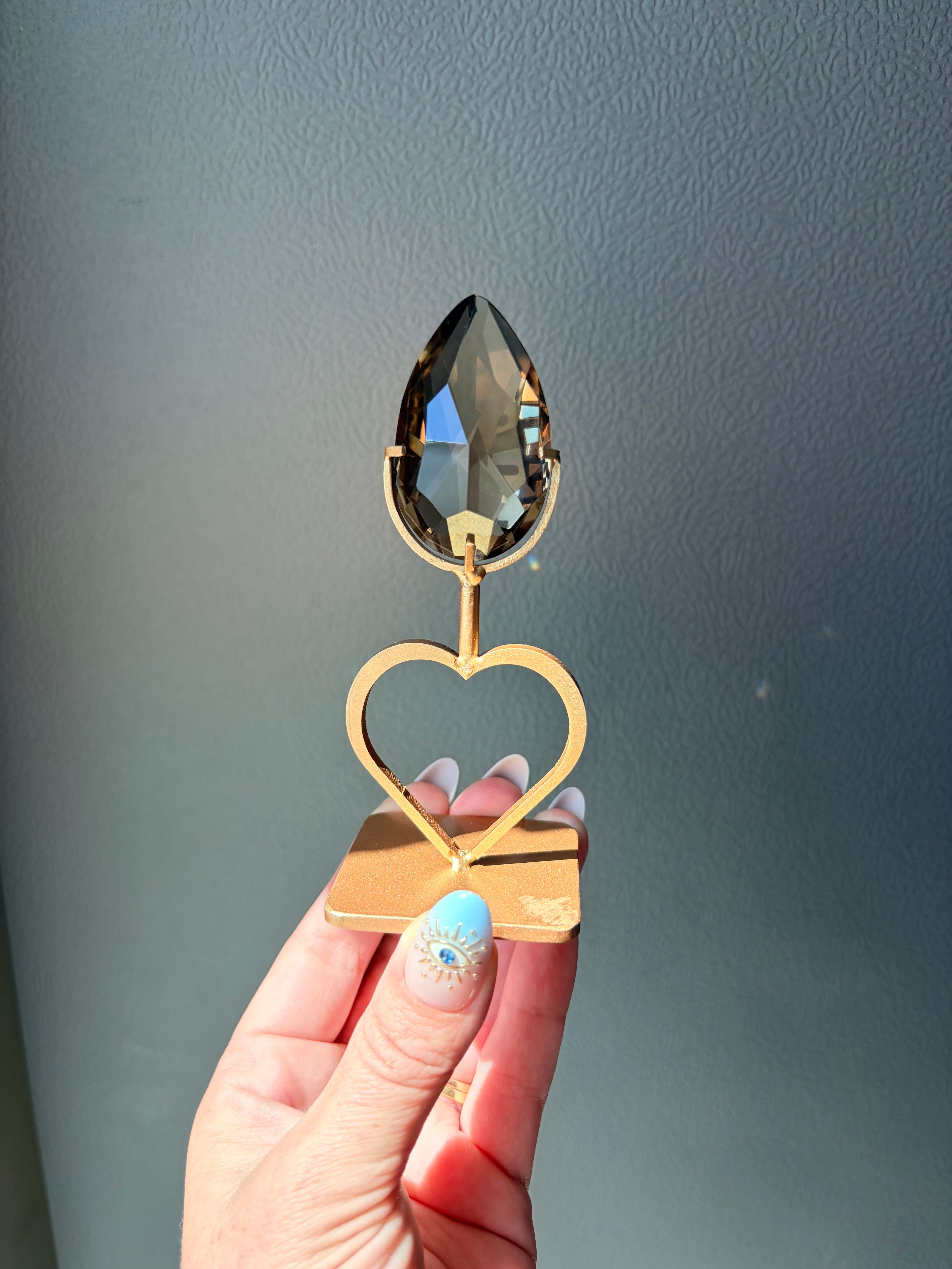 Faceted Smoky Quartz Gem on Heart Gold Stand