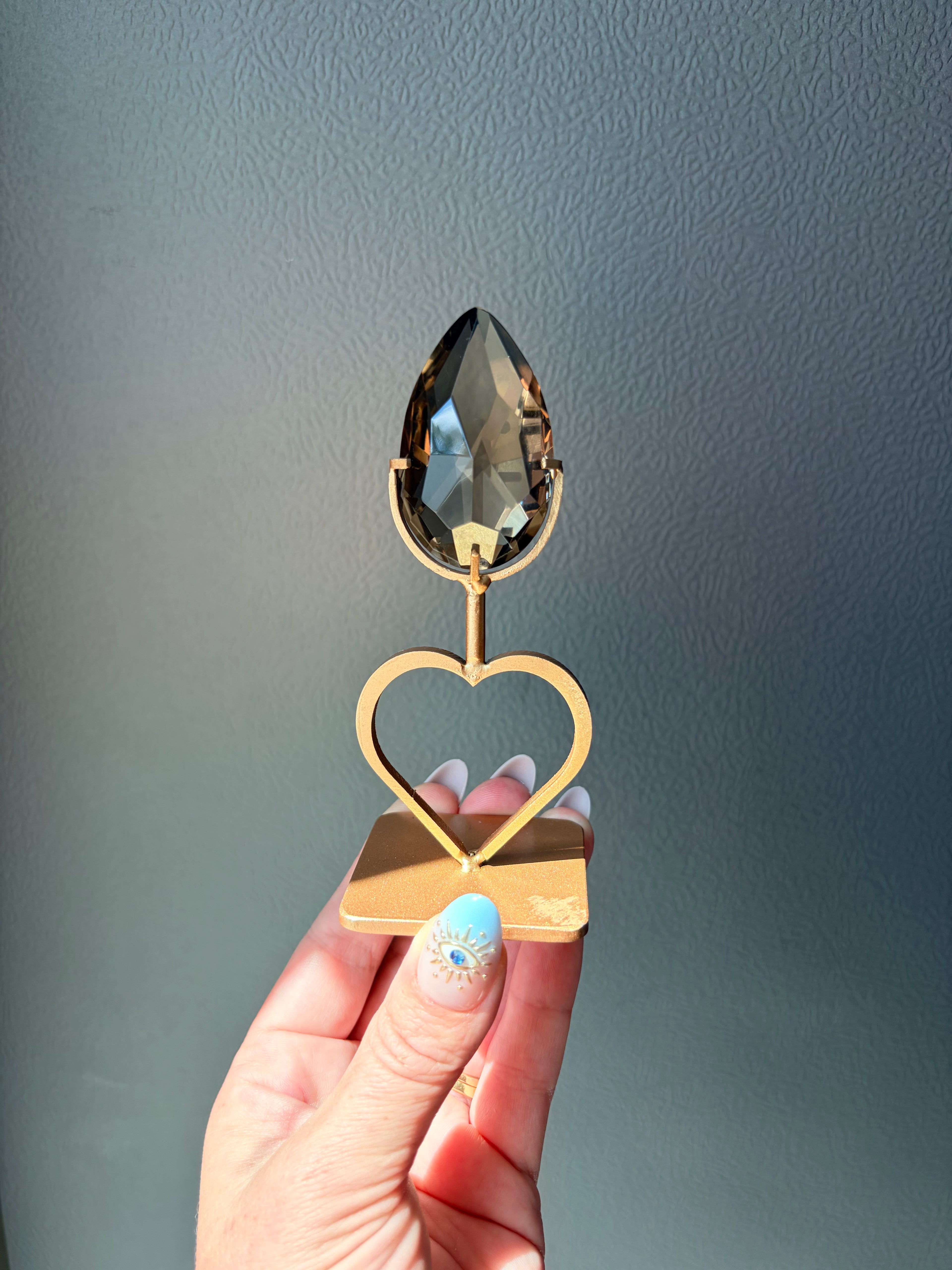 Faceted Smoky Quartz Gem on Heart Gold Stand