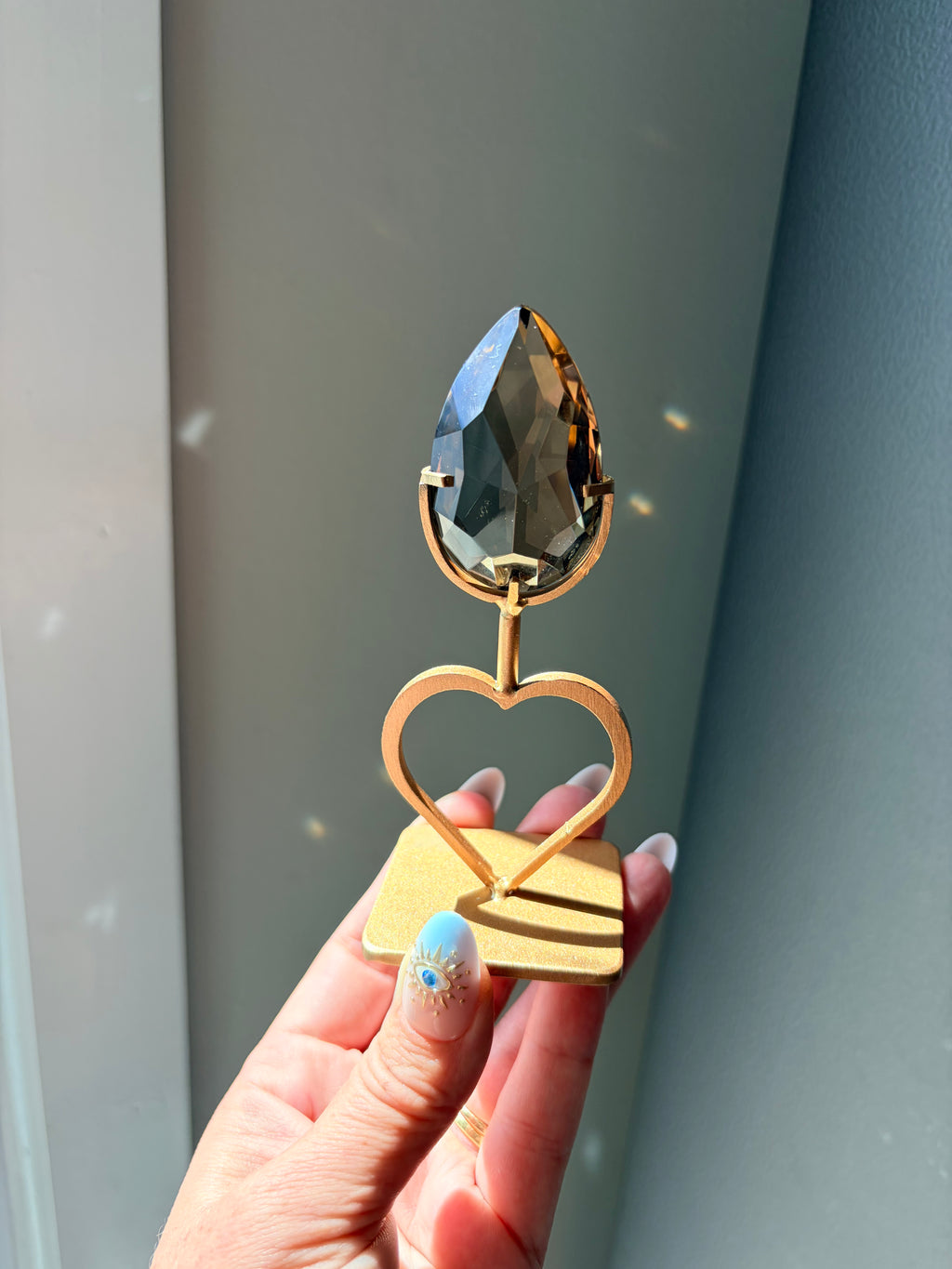 Faceted Smoky Quartz Gem on Heart Gold Stand